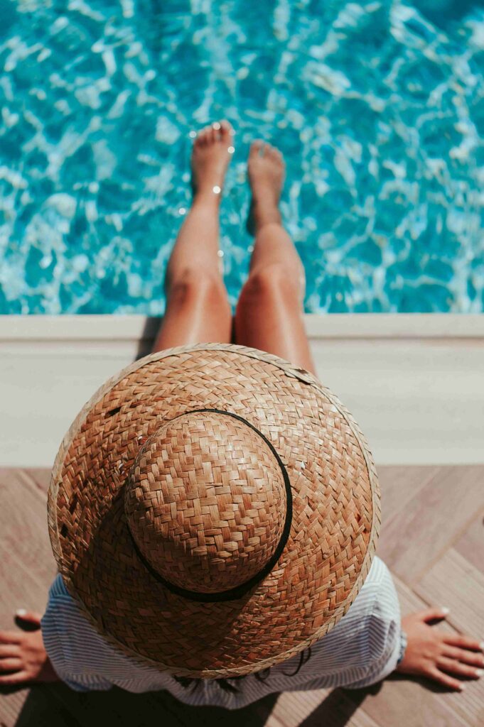 a woman sitting at the pool